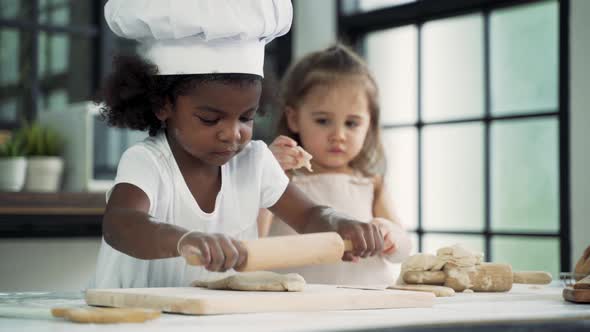 Diverse Group of Kids Prepare Dough and Bake Cookies in Kitchen While Learning in Class at School