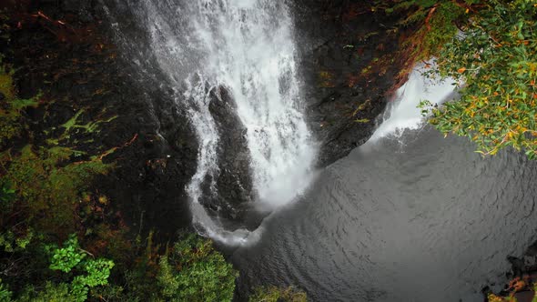 Drone close up shot of waterfall and the lake below at Opaekaa Falls, Kauai, Hawaii, USA
