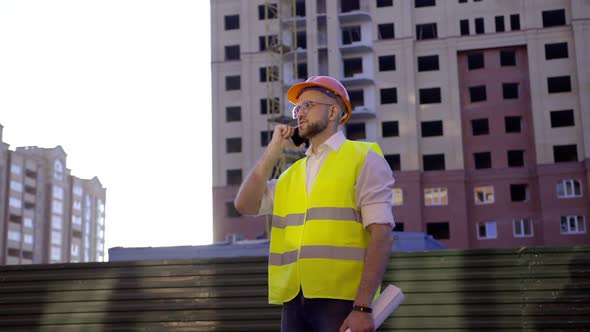 Young Builder Talks on His Phone