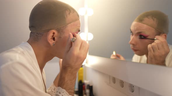 Side View Focused Genderfluid Woman Applying Mascara in Slow Motion Reflecting in Mirror