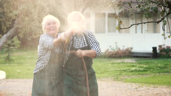 Old Couple with Garden Hose.