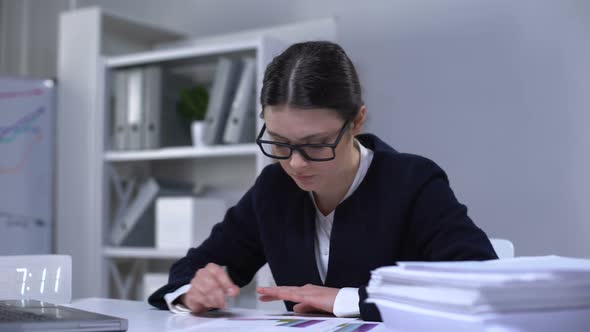 Satisfied Lady Bookkeeper Looking Through Documents, Feeling Happy With Work