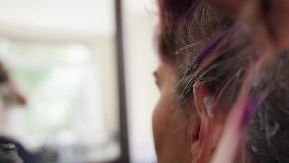 Close up view woman having her hair styled by a hairdresser