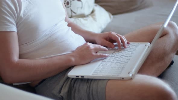 Young Man Freelancer Student Using Laptop Studying Online Working From Home in Internet Smiling