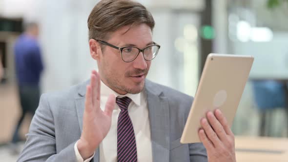 Portrait of Businessman Doing Online Video Chat on Digital Tablet 