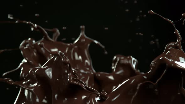 Super Slow Motion Shot of Splashing Melted Chocolate Isolated on Black Background at 1000 Fps alt