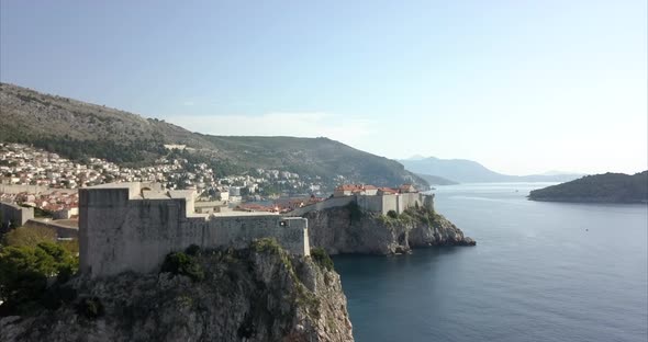 Fort Lovrijenac in Dubrovnik, the camera rises slowly to reveal old town in the distance and the coa