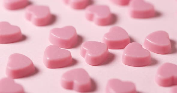 Pink chocolate candy on pink background