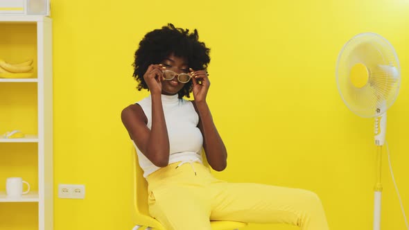 Confident African Woman Model Is Putting On Glasses