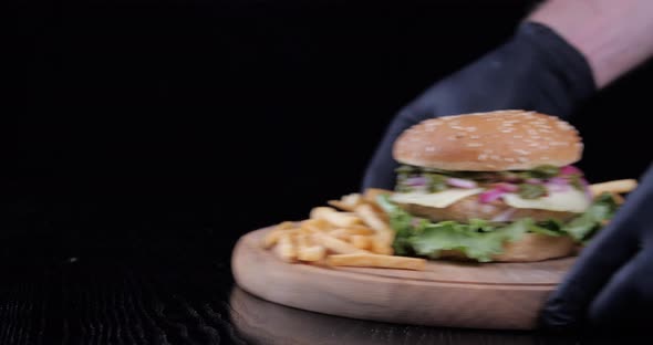 Closeup Side View Delicious Fast Food Dish French Fries and Hamburger with Meat Beef Salad Dressing