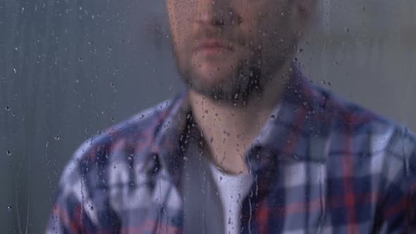 Lonely Depressed Male Looking in Window on Rainy Day, Life Troubles, Sadness