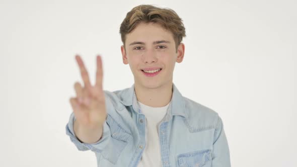 Young Man Showing Victory Sign on White Background