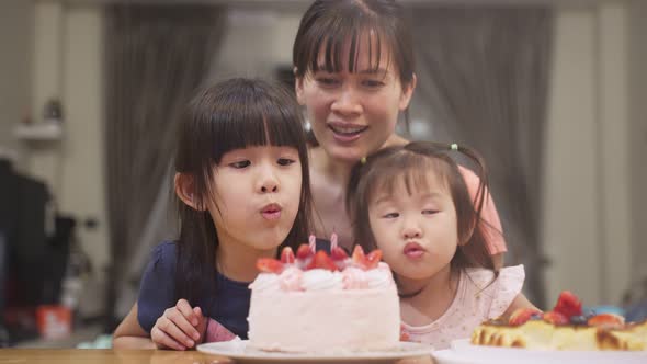 Asian happy young family have birthday party for young little child together at home. Lovely moment.