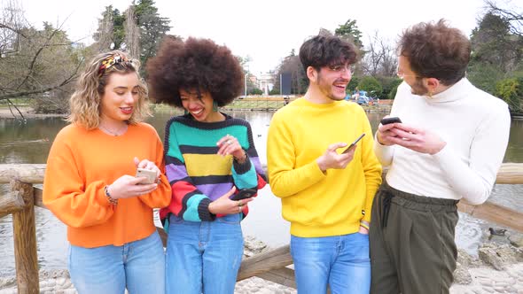 Slow motion group of multiethnic friends millennials using mobile phones