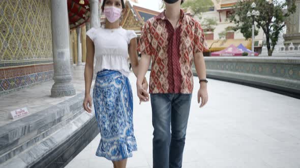 Japanese Guy and Transgender Thai Couple in Masks Visiting and Praying at Wat Ratchabophit