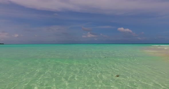 Luxury flying clean view of a summer white paradise sand beach and turquoise sea background in 4K