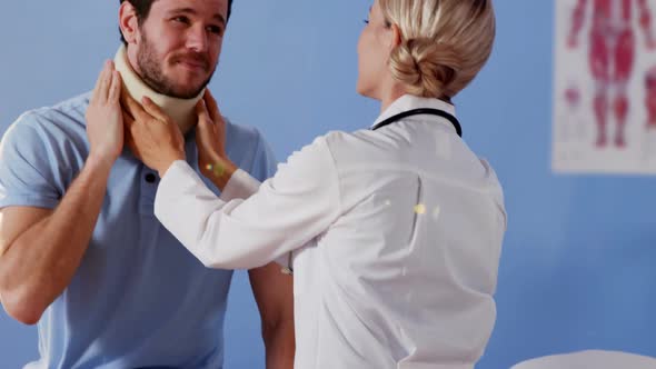 Physiotherapist examining neck of a female patient