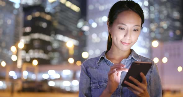 Woman use of smart phone at night 