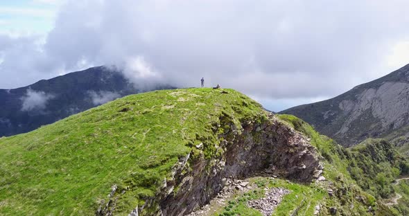 Aerial drone view of a man taking a selfie dronie on a hill top in Montenegro.