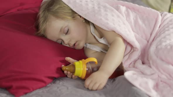 Cute Baby Sleeping on the Bed at Home. Little Girl Sleeping in Morning Light