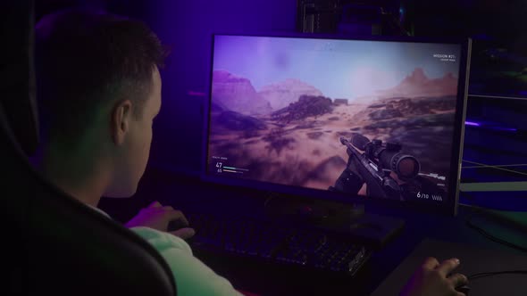 Young Gamer Boy Focuses On A War Battle Simulator Multiplayer Game Play alt