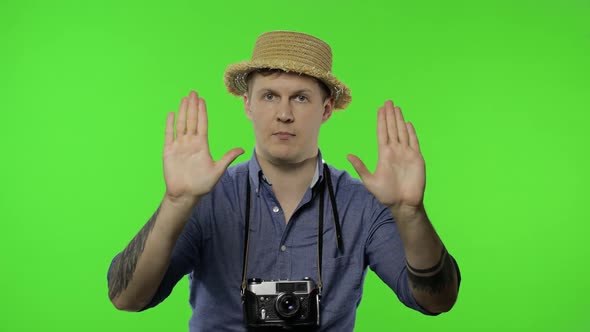 Portrait of Young Man Tourist Photographer Show Stop Sign. Chroma Key