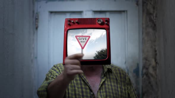 Man with Old TV instead of Head, showing a Give Way Sign on Screen.