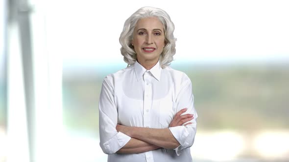 Portrait of Senior Businesswoman on Blurred Background.