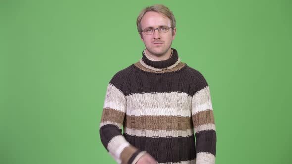 Studio Shot of Blonde Handsome Man with Arms Crossed