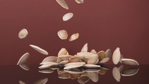 Flying Pumpkin Seeds on a Brown Background