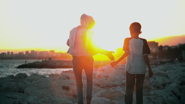 Syrian Refugee Brothers At Sunset.