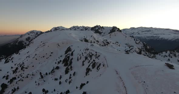 Summit of the French Alps at Chamrousse during early sunrise, Aerial flyover shot