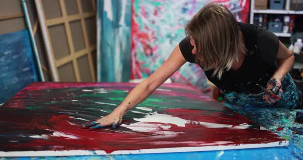 Mature woman painting inside her atelier studio