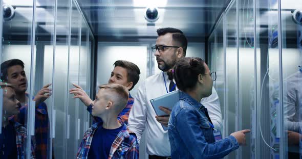 IT Technician Showing Around Children in a Server Park