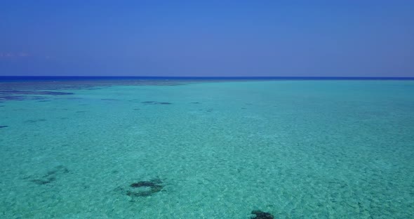 Natural overhead clean view of a white paradise beach and blue water background in hi res 4K