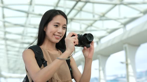 Woman travel in Hong Kong and taking photo with digital camera 