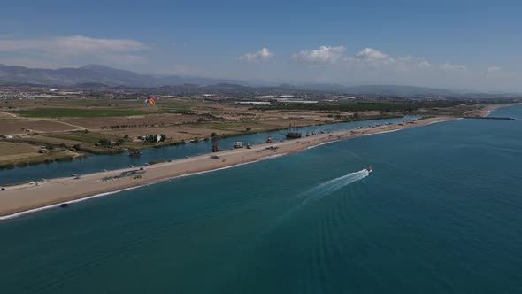 Parasiling By Speedboat on a Wide Shore