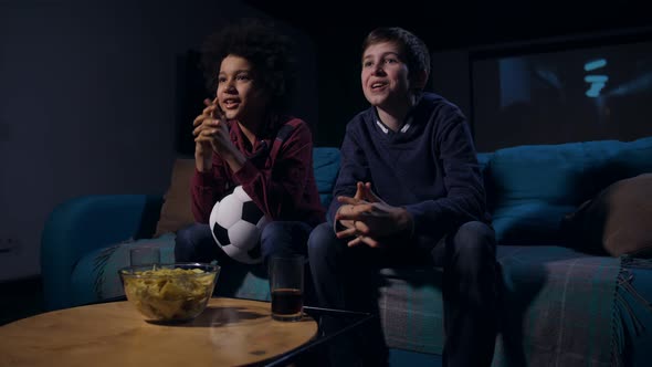 Soccer Fan Teens Emotionally Watching Match on TV