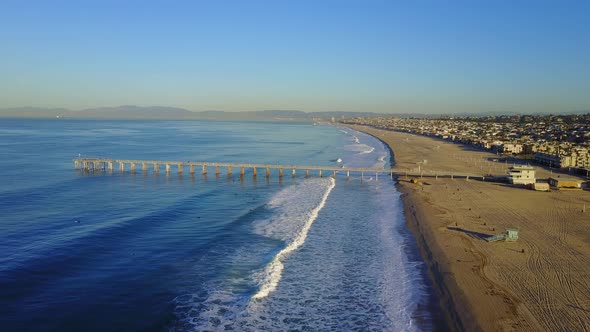 Aerial drone uav view of a pier over the beach and ocean.