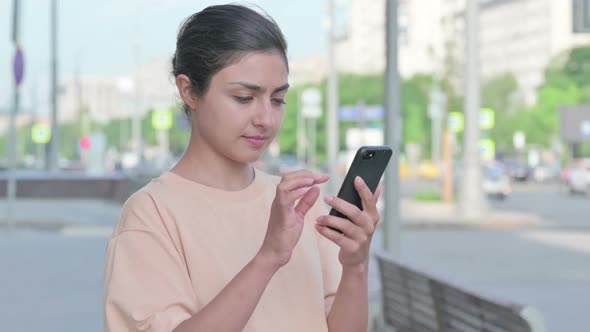 Portrait of Indian Woman Browsing Internet on Smartphone