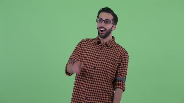 Happy Young Bearded Persian Hipster Man Waving Hand