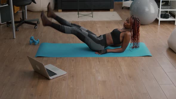 Athletic Fit Woman Doing Scissors Exercise Sitting on Yoga Map