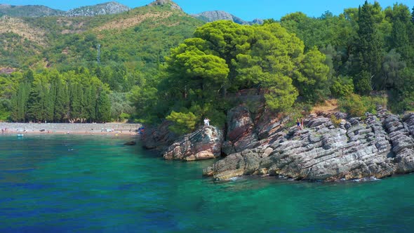 Young Couple Enjoying Mediterranean Turquoise Sea in Rocky Coast Montenegro