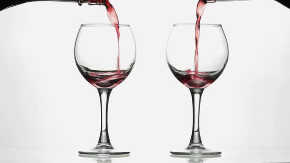 Rose Wine. Red Wine Pour in Two Wine Glasses Over White Background