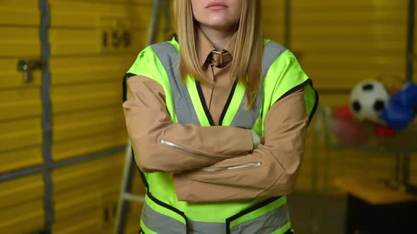 Front View Unrecognizable Female Employee Crossing Hands Standing in Industrial Warehouse
