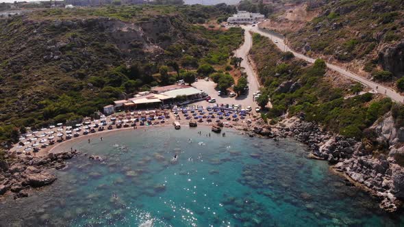 birds eye view rising up over anthony quinn bay in rhodes island showing the whole environment with