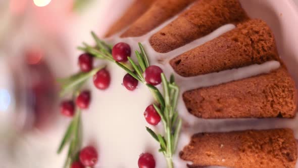 Christmas cake topped with sugar icing, cranberry and rosemary. Vertical video