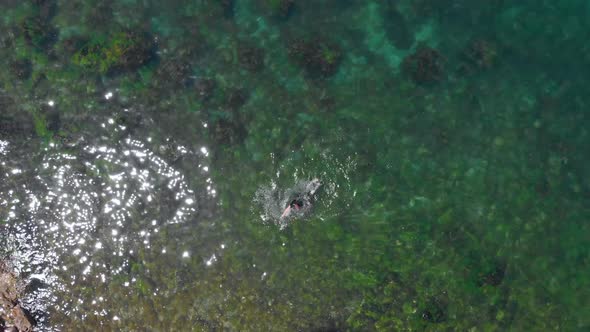Top view of a person swimming in island beach, summer vibes
