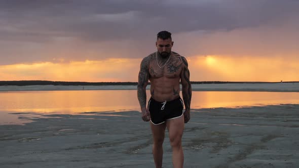 Masculine Man on Shore at Sunset