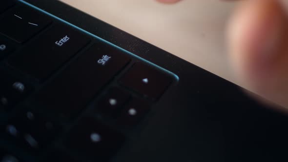 Shot From Above of a Part of a Laptop Keyboard with the Hand of a Working Person